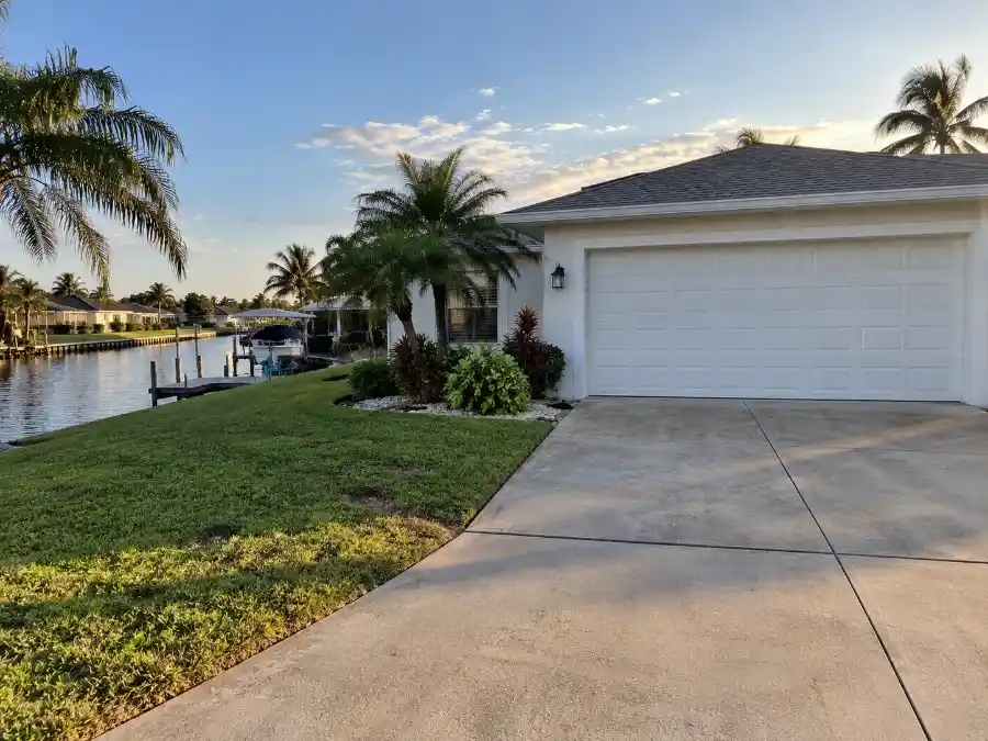 Garage Door Repair Cost in Palm Coast, FL 4 Canal-front home in Palm Coast FL F Section showing a residential garage door in a high salt-air exposure area near the Intracoastal Waterway in Flagler County
