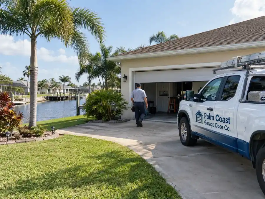 Garage Door Spring Repair & Replacement — Palm Coast, FL 4 Palm Coast Garage Door Co. service truck at a canal-side home in Palm Coast Florida